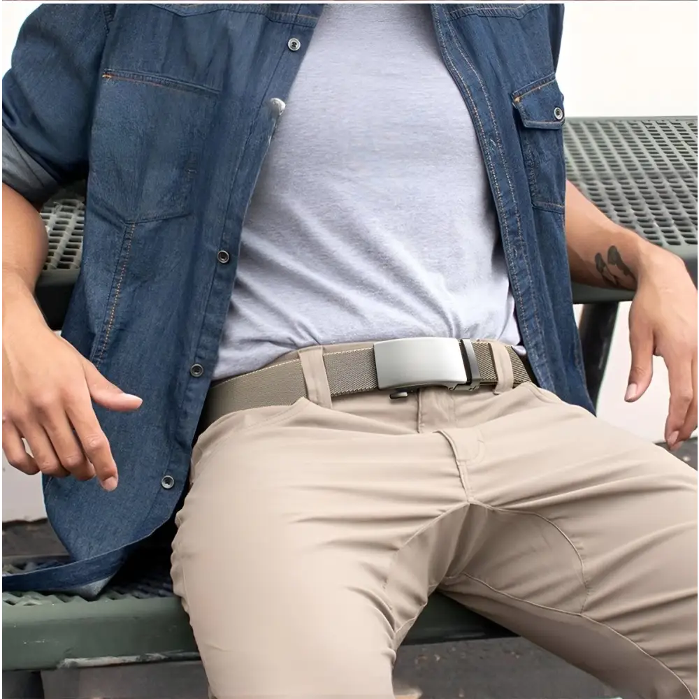 Tan pants paired with a silver buckle belt from the Assorted Nylon and Fabric Web Belts collection