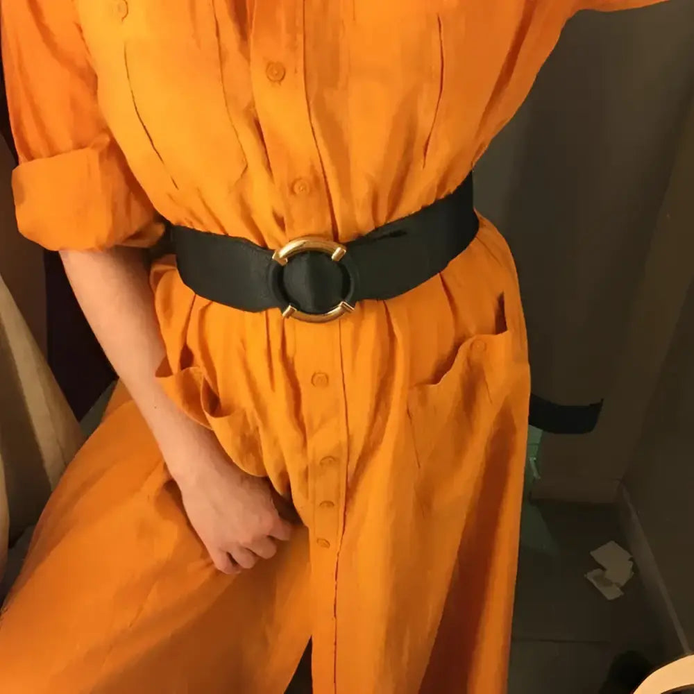Orange button-down dress with black elastic belt featuring a gold buckle for stylish outfits