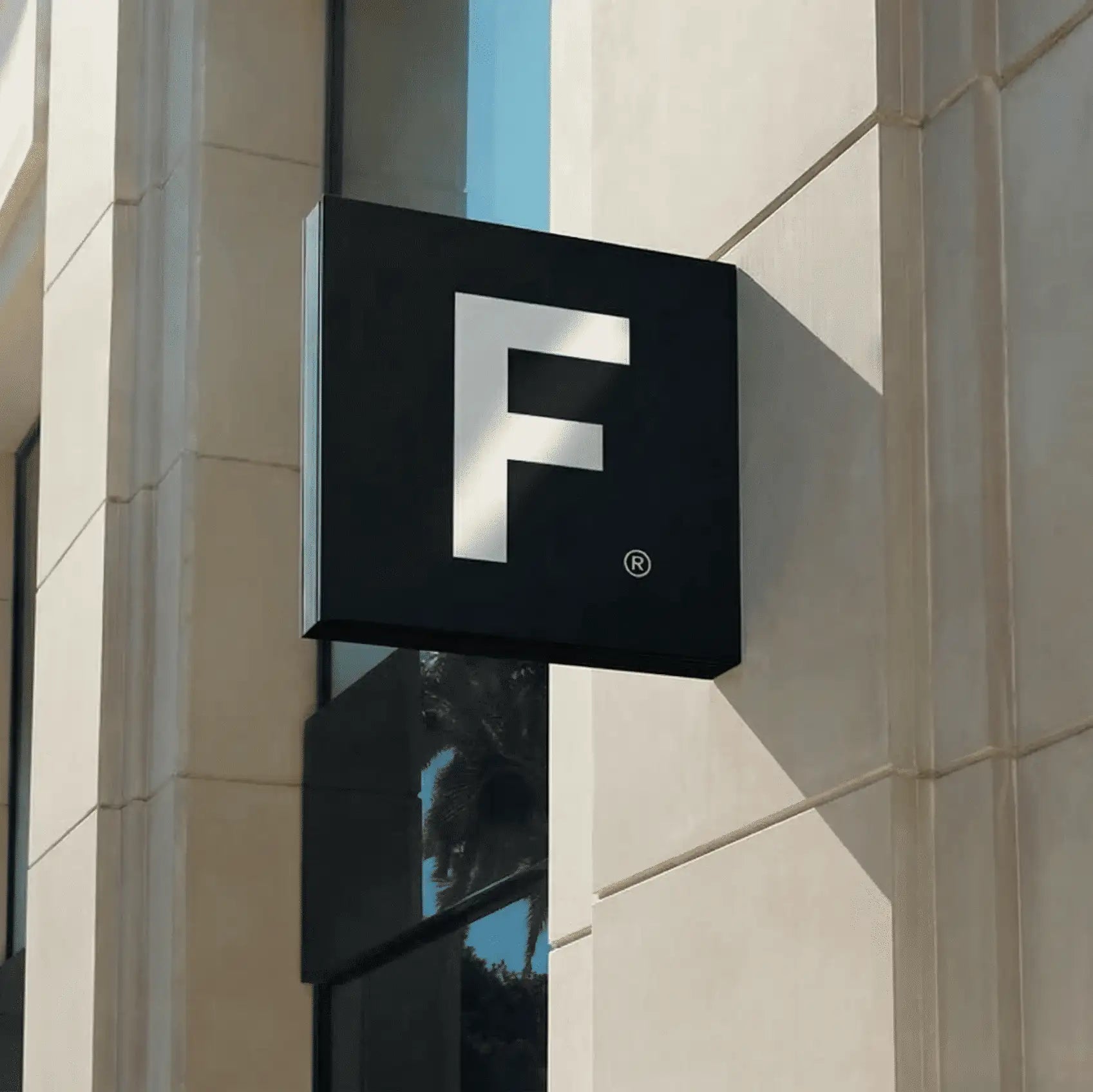 Black square sign with a bold white capital letter ’f’ and a registered trademark symbol in the corner.