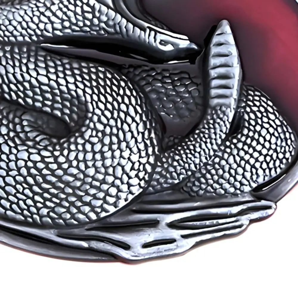 Silver snake belt buckle coiled on red background for elegant style showcasing craftsmanship