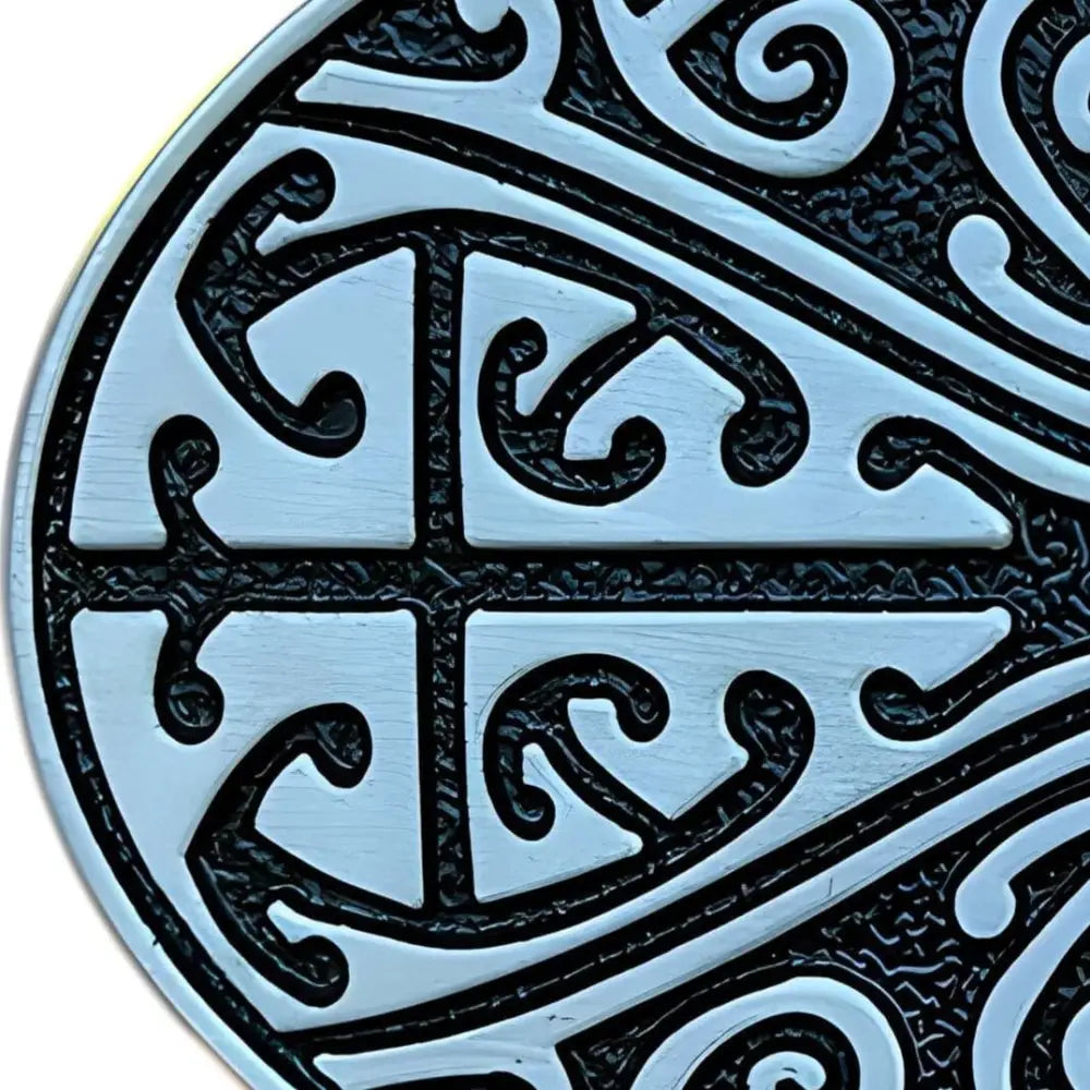 Circular Maori-inspired metalwork on an ancient Celtic herbod belt buckle with silver and black design