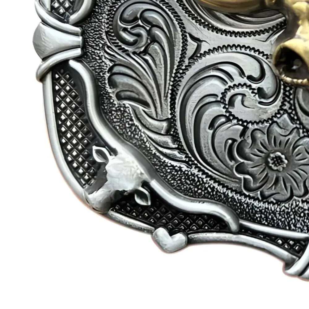 Ornate silver and gold belt buckle featuring a bull skull design for Western fashion