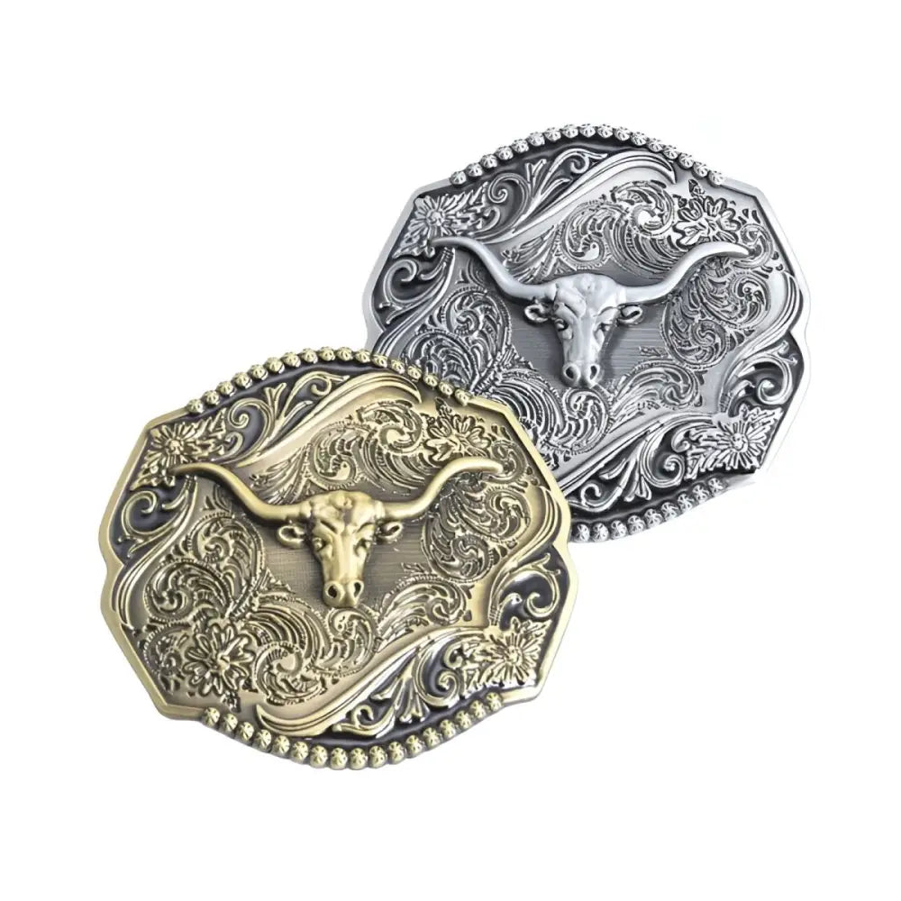 Two ornate bull belt buckles featuring silver and gold Cyrus belt buckles and belts