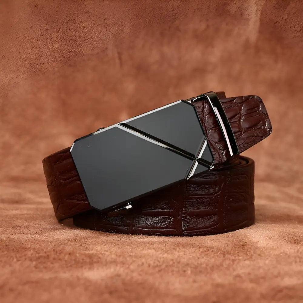 Brown crocodile-patterned leather belt with a black geometric buckle and silver accents
