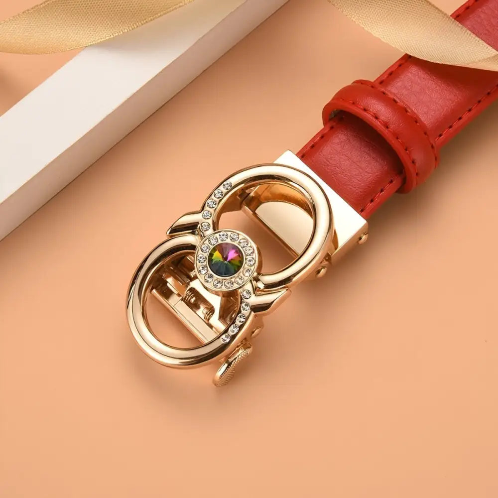 Red leather belt featuring a jeweled gold buckle for an elegant fashion accessory