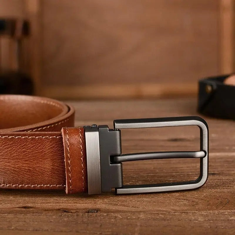 Set of three leather belts with metal buckles including a brown leather belt with silver buckle