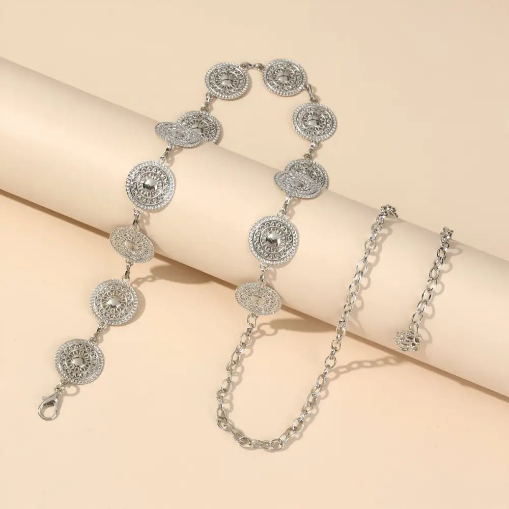 Silver Orya Chain Belt with Circular Medallions enhances aesthetic appeal for black mini skirts