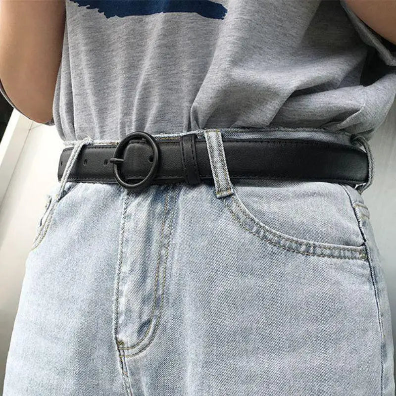 Black leather belt with round buckle, stylish and durable accessory for formal wear