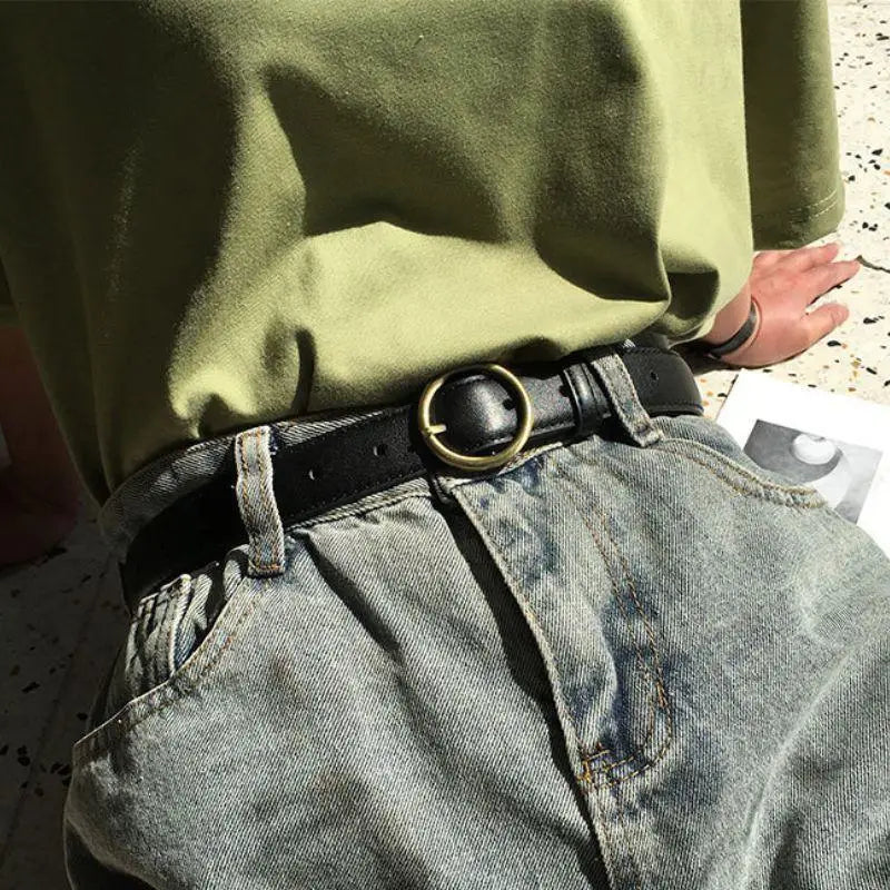 Black leather belt featuring a gold round buckle for a stylish and sophisticated look