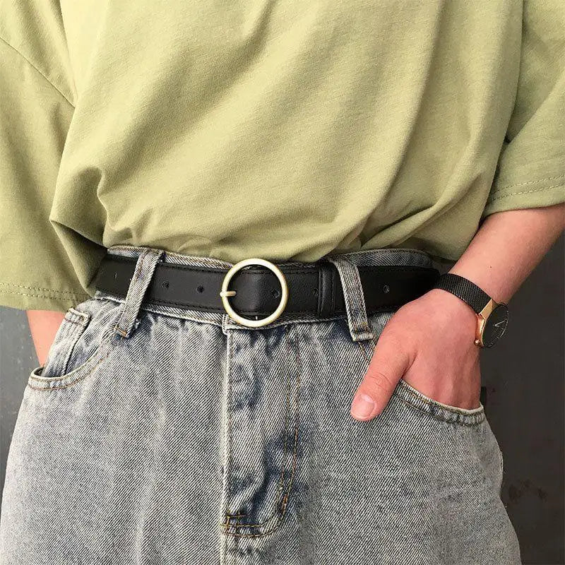 Black leather belt featuring a gold round buckle for a sophisticated look