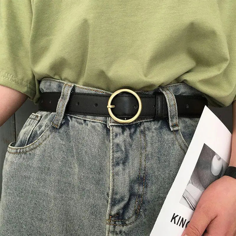 Black leather belt featuring a gold round buckle for a stylish, sophisticated look