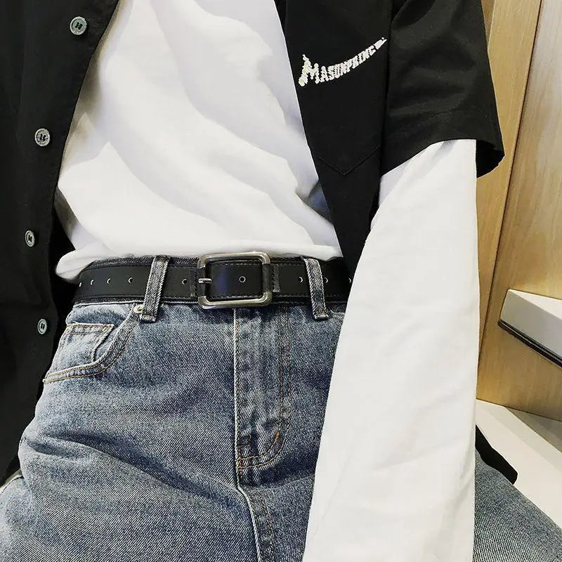 Blue jeans paired with a black leather belt featuring a square metal buckle