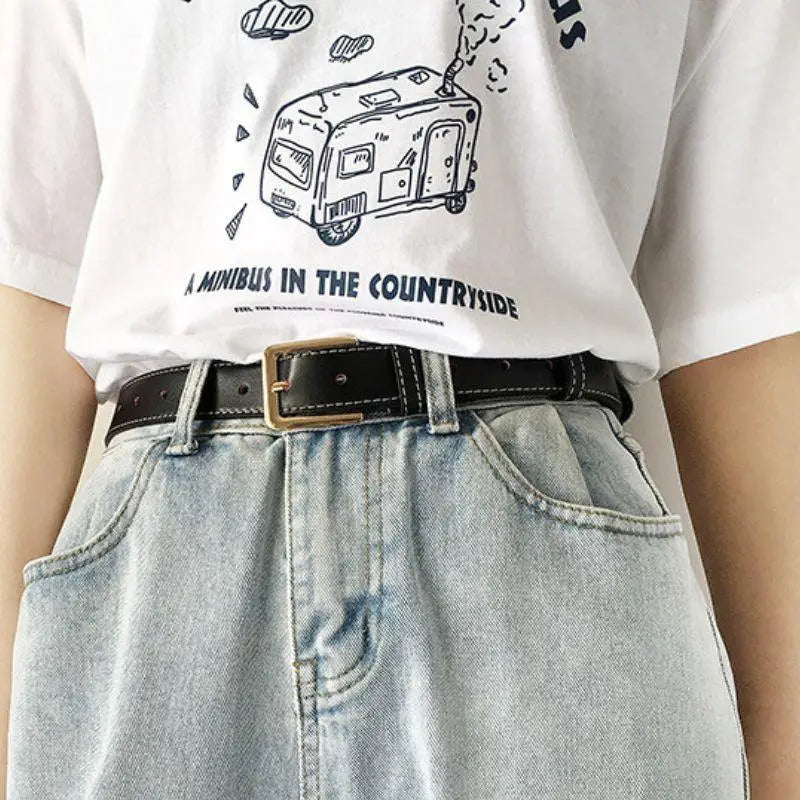 Light blue denim jeans with a black Benedicte Belt featuring a gold buckle