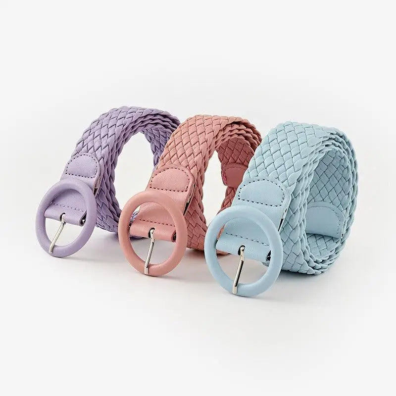 Three pastel braided belts with round buckles displayed for casual wear