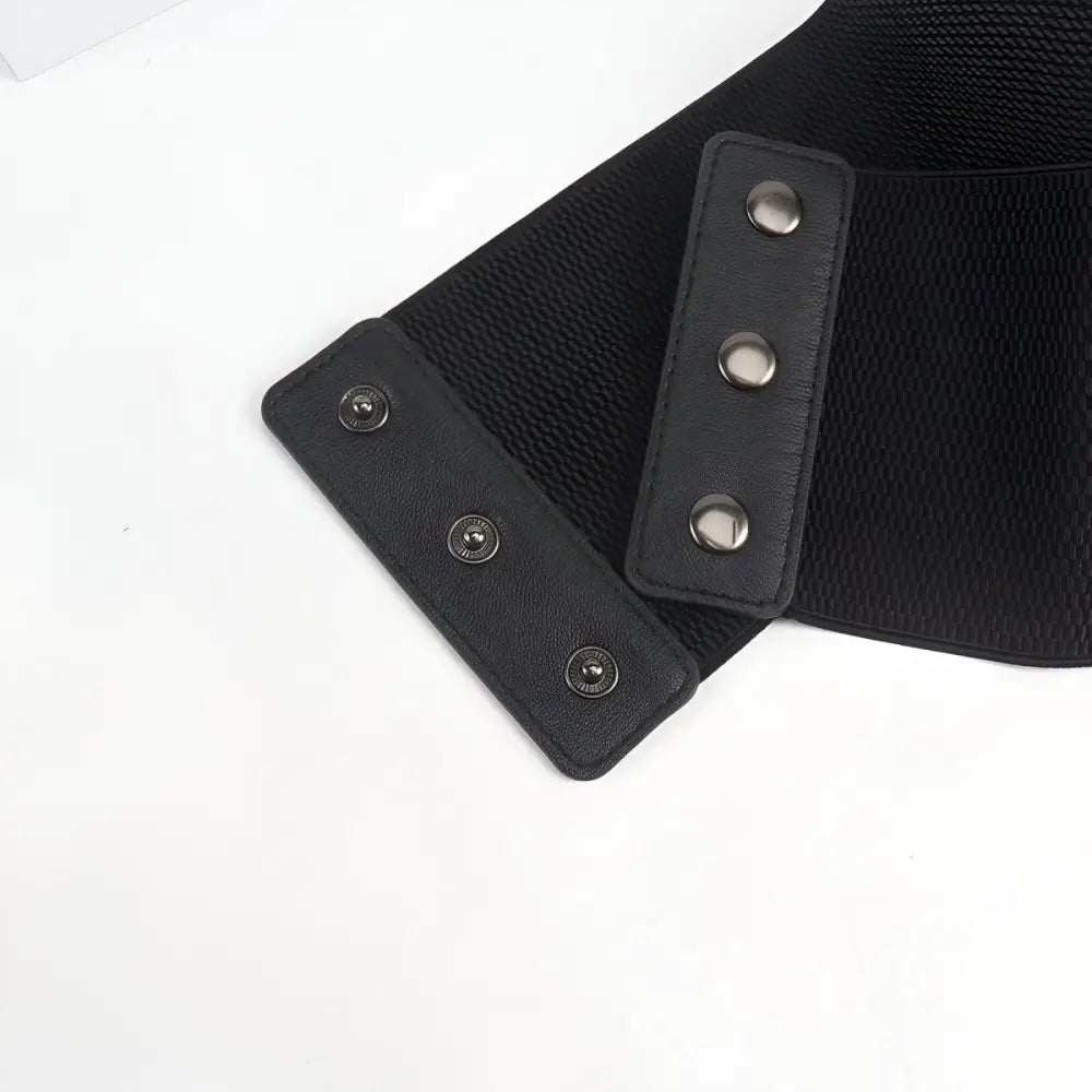 Black elastic corset belt with silver grommets and snap closures for stylish waist accents