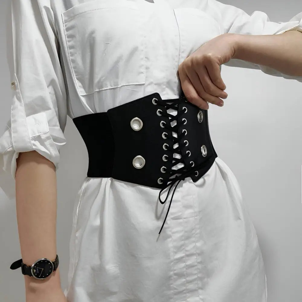 Black corset belt with silver grommets for stylish waist accents