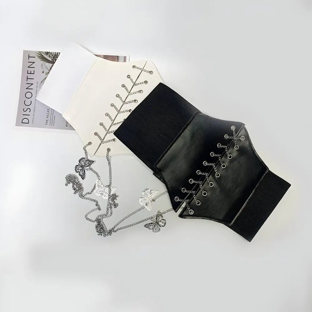 Black and white corset belt with decorative butterfly chain accents for stylish wear