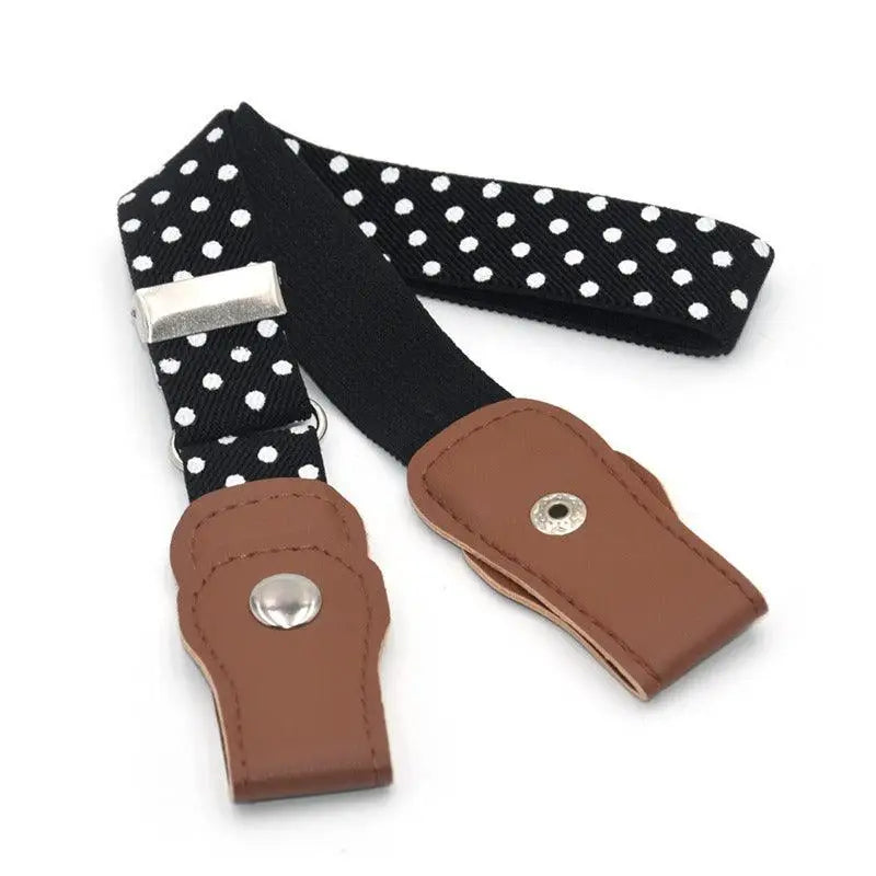 Black and white polka dot suspenders worn with denim shorts and an orange belt