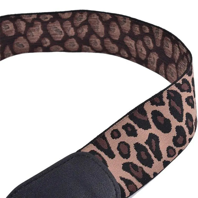Leopard print guitar strap complementing Cream Ribbed Dress with Black Belt and Gold Circling