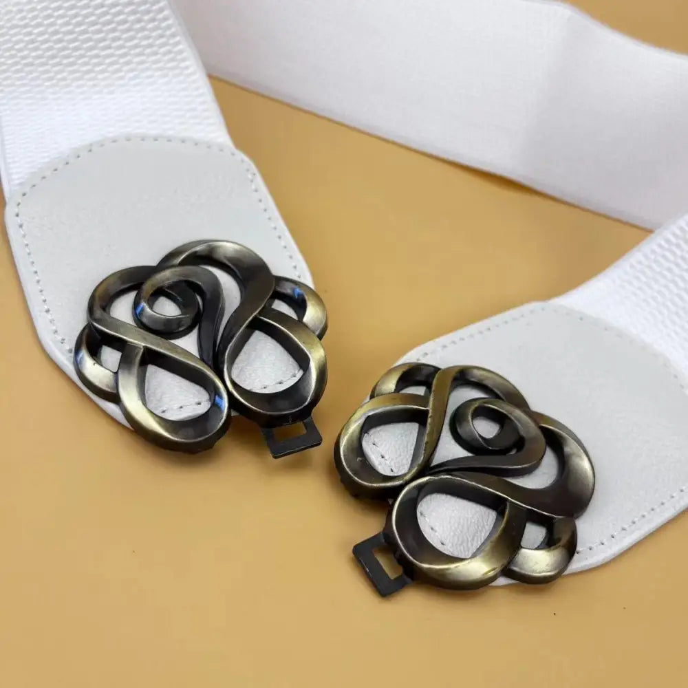 White elastic belt with ornate metal clasps from the Natasja Elastic Belt Collection