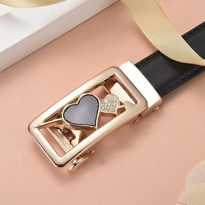 Gold-toned belt buckle with heart designs on decorative red leather belt