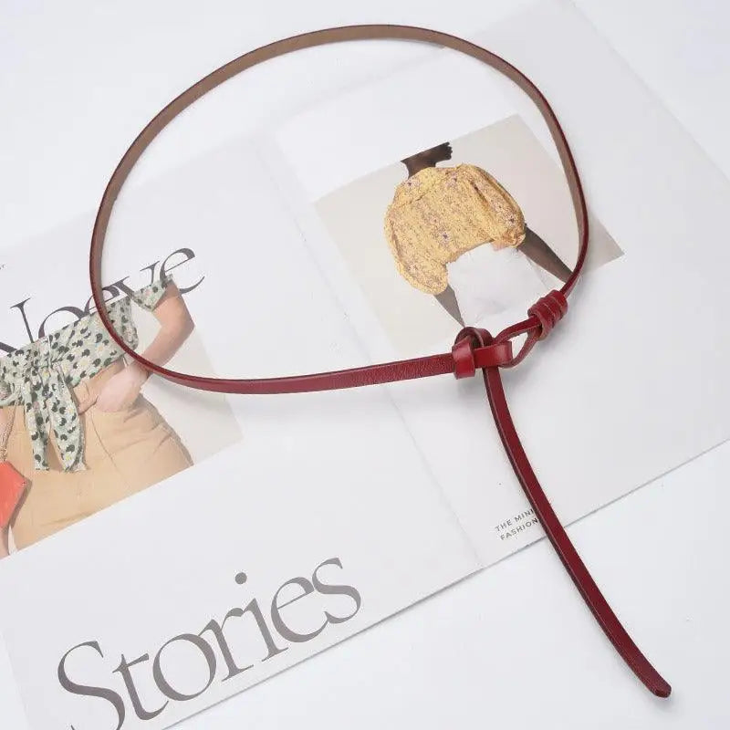 Burgundy leather tie belt with knotted closure showcasing stylish aesthetic appeal