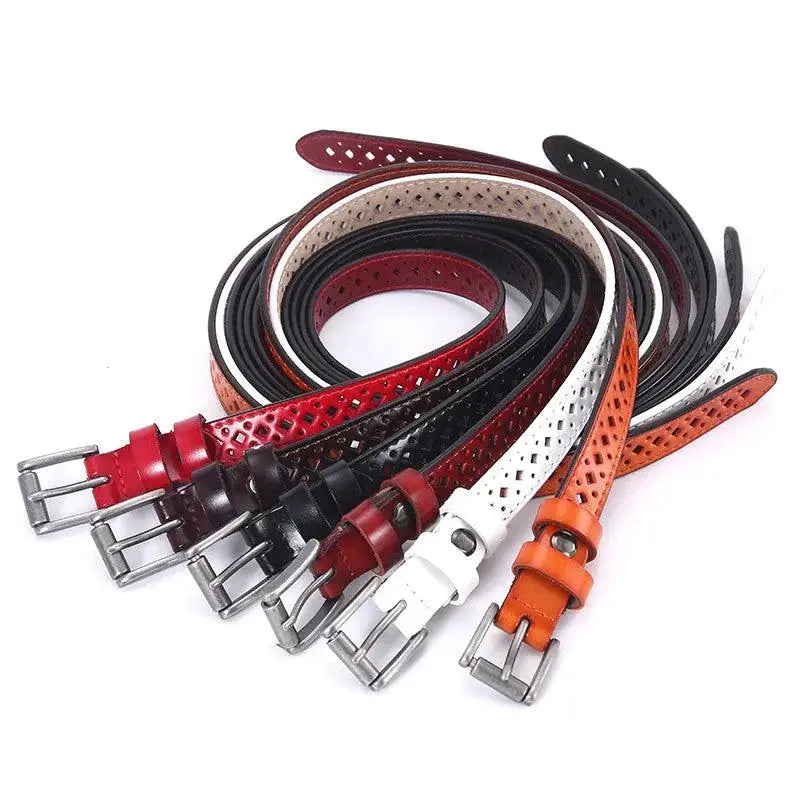 Colorful perforated leather belts displayed with Distressed Denim Shorts featuring a red leather belt