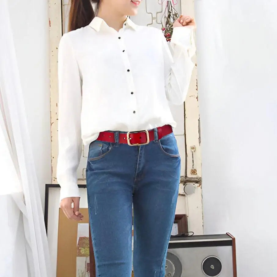 Red belt with gold buckle accessory for Women’s Outfit including white sweater and blue jeans