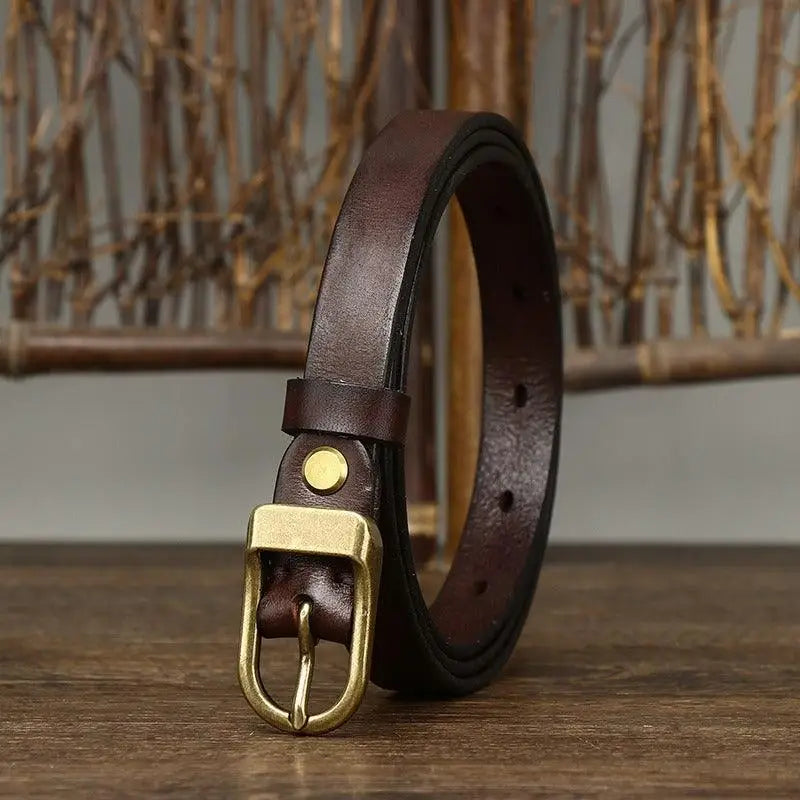 Set of four full-grain leather belts with brass and gold buckles displayed