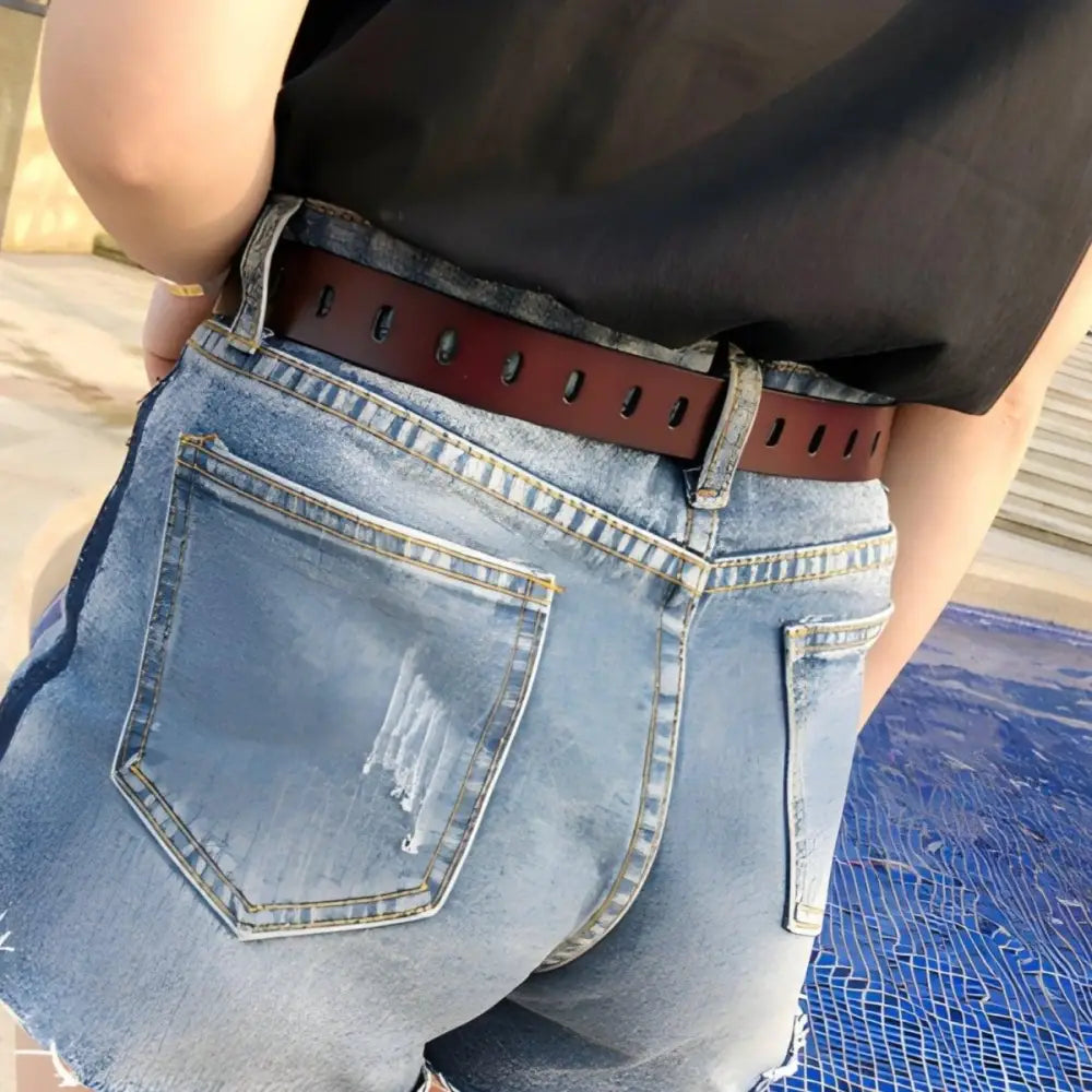 Distressed denim shorts with Gulisa leather belt and red leather band for stylish wear