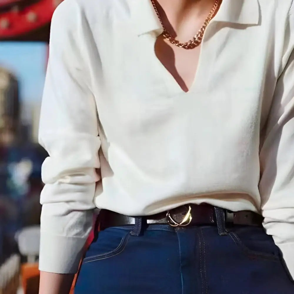 White long-sleeved shirt with gold chain paired with genuine leather women’s belt featuring snap buckle