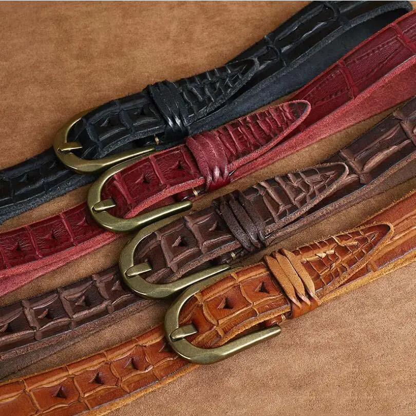 Four textured leather belts showcasing quality craftsmanship and crocodile pattern details