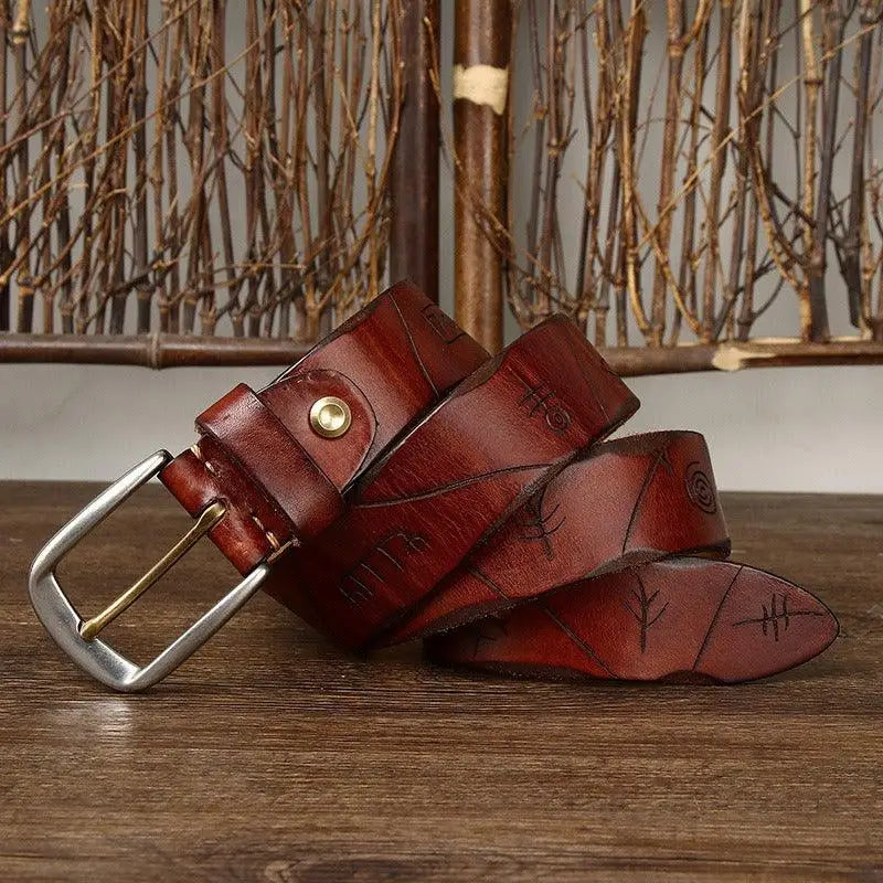 Embossed brown leather belt with silver buckle from assorted brown and maroon leather belts