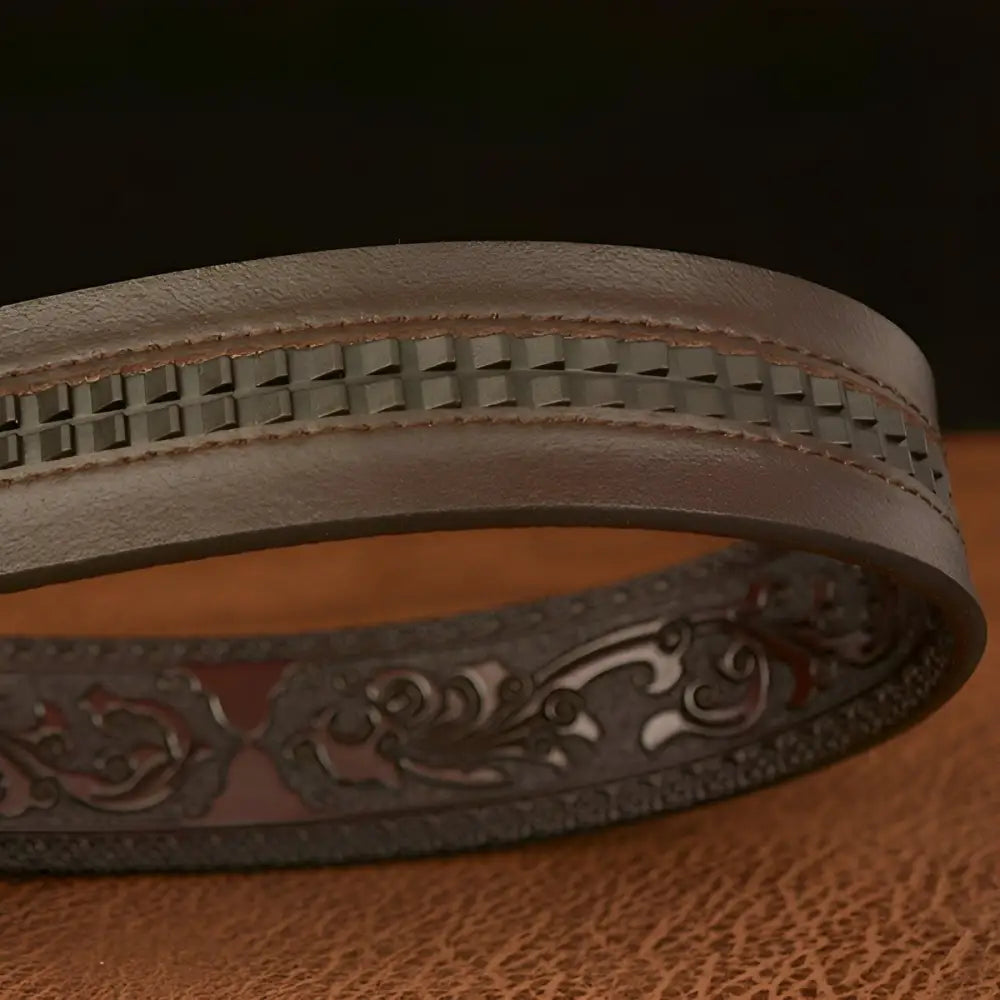 Embossed brown leather belt with decorative patterns and dragon buckle detail
