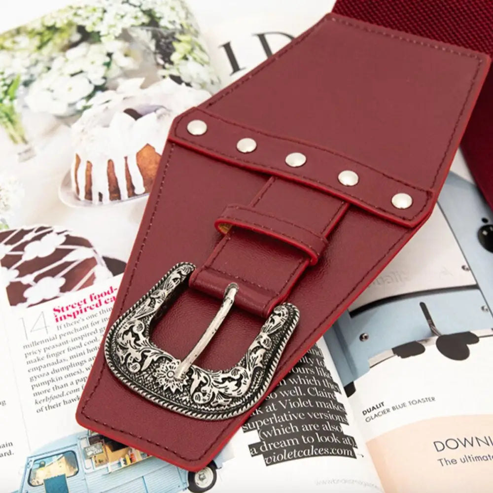 Maroon corset belt with decorative buckle from the Kirsten Belt collection for women’s dresses