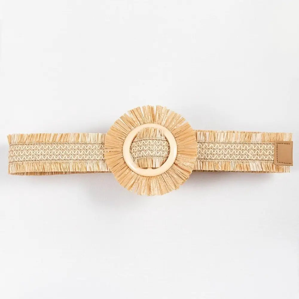 Woven raffia straw belt with circular buckle and fringe detailing for a stylish look