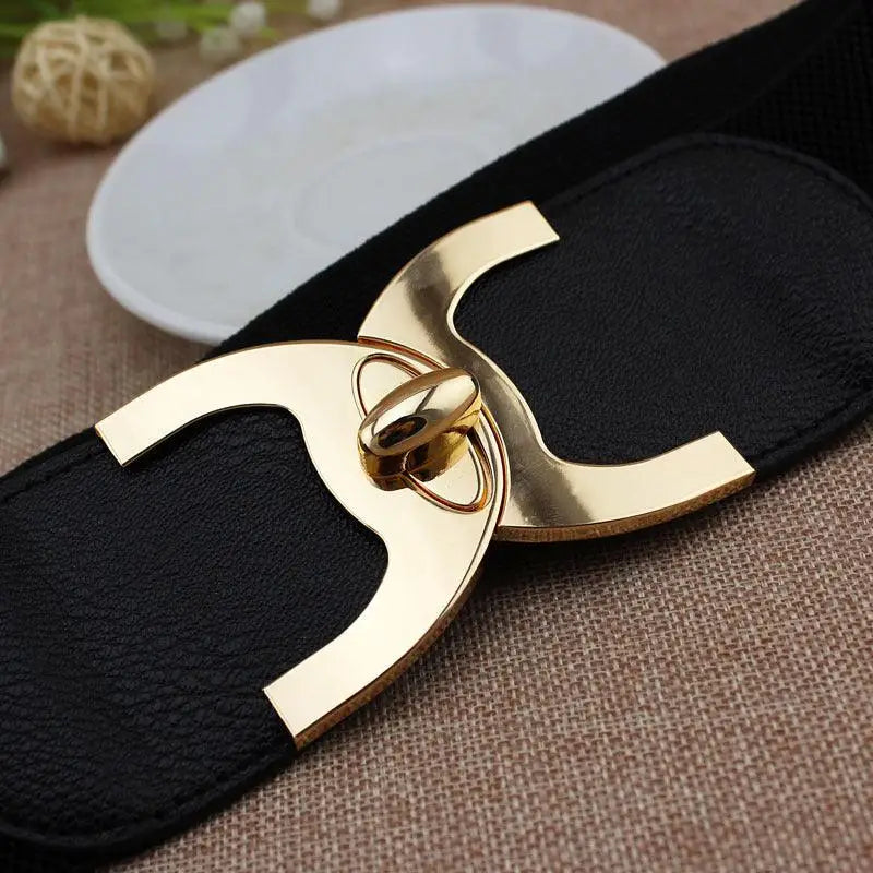 Black elastic waist belt featuring a gold decorative buckle for stylish accessory options