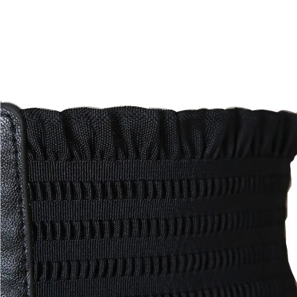 Black elastic smocked fabric featured on a white elastic waist belt with buttons and black corset belts