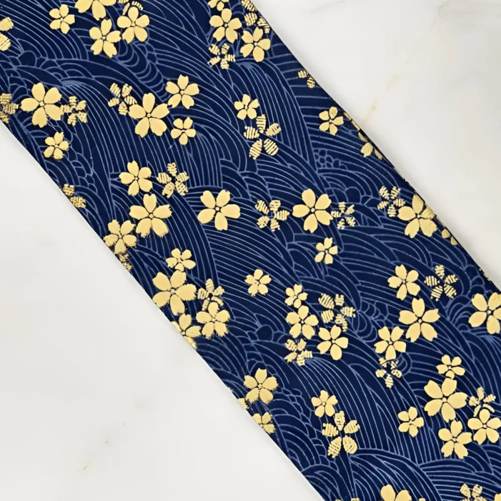 Blue fabric with yellow floral pattern showcasing sakura flower-patterned obi and strap