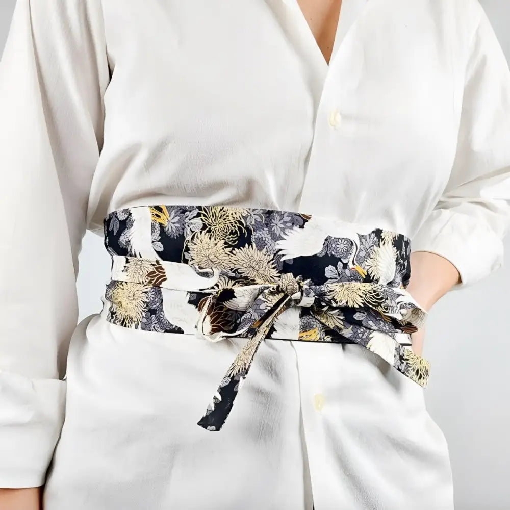Floral patterned Obi Mita belt with crane design displayed with Black Fabric Bag