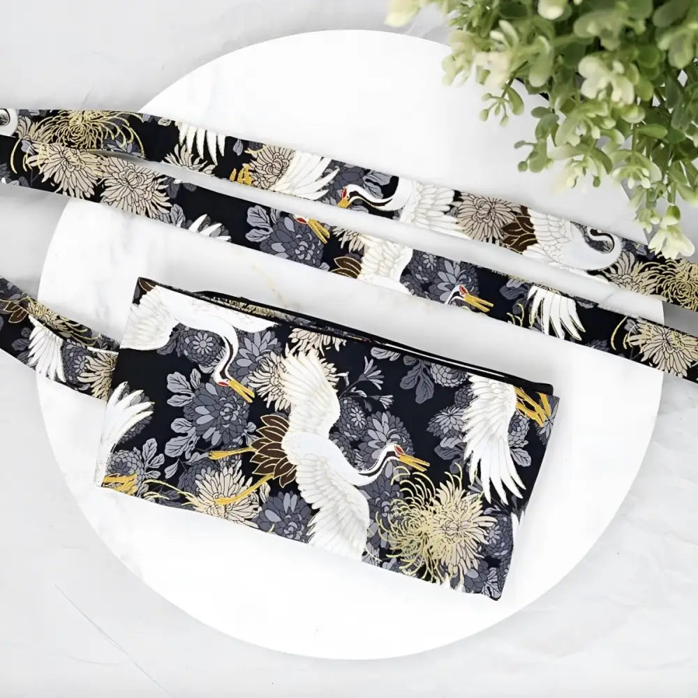 Black fabric bag with crane and floral pattern showcasing an Obi Mita Belt design