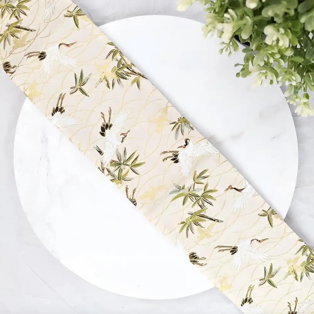 Cream crane patterned fabric with crane patterned obi and bamboo design for traditional attire