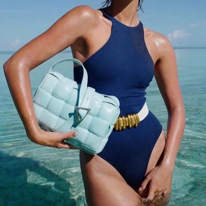 Light blue woven leather handbag featuring a Madona belt for trendy women’s fashion