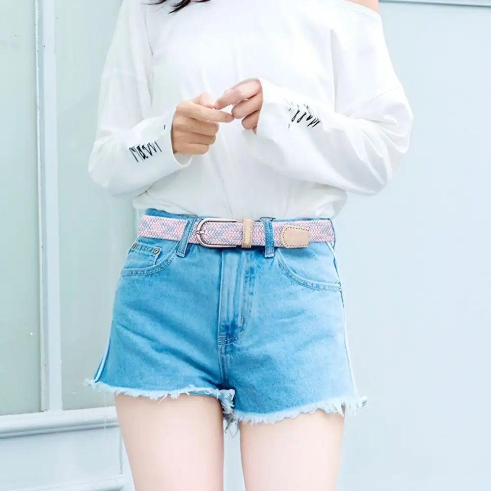 Adelina belt with pink leather accents paired with denim shorts for a stylish look