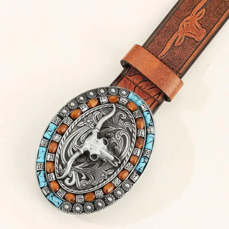 Brown leather belt with an oval steer skull buckle showcasing Western style