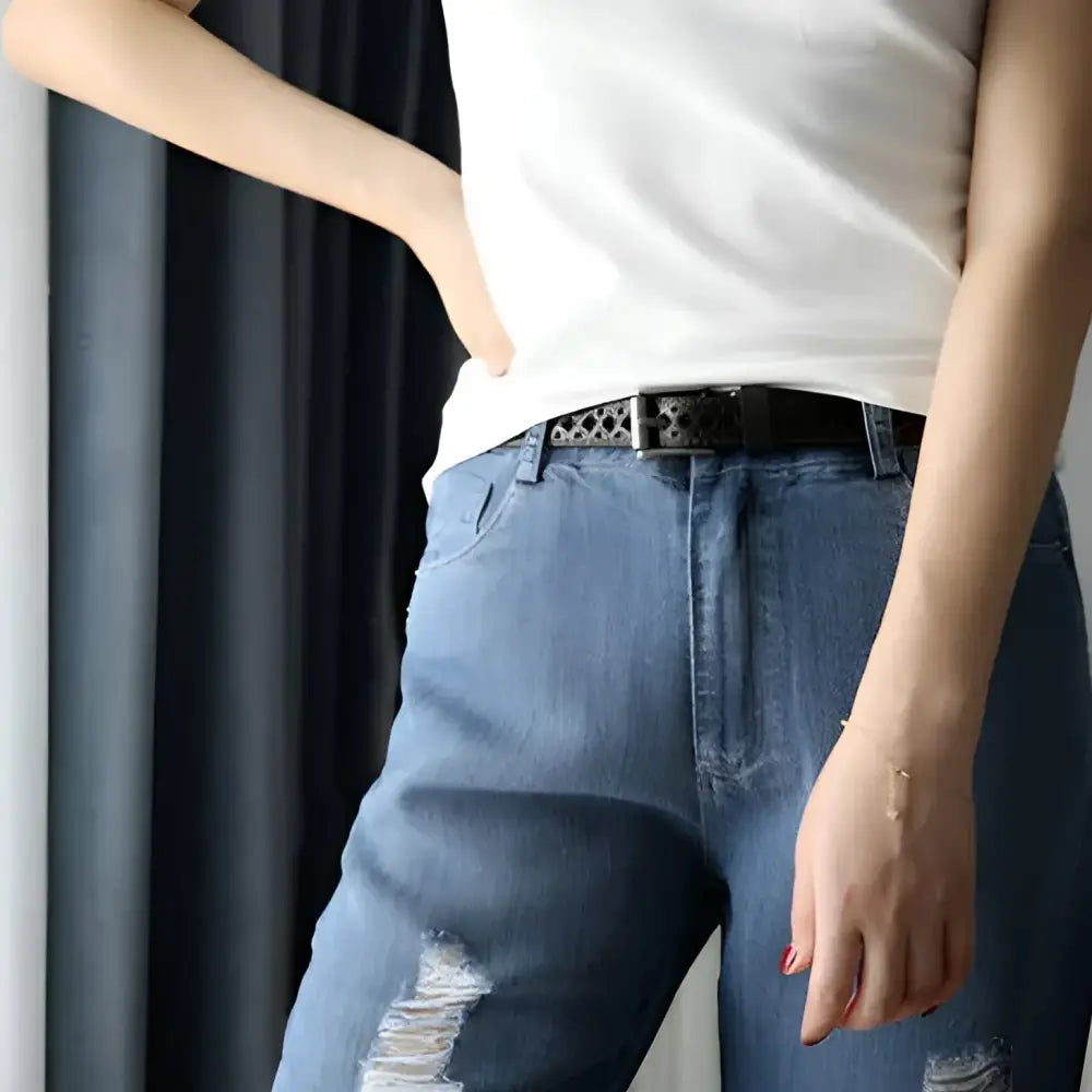 Ripped blue jeans with a black leather belt featured on Distressed Denim Shorts with Red Leather Belt