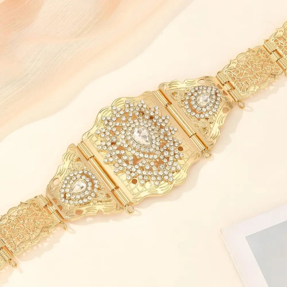 Elegant gold tone metal belt with intricate rhinestones for sophisticated fashion style