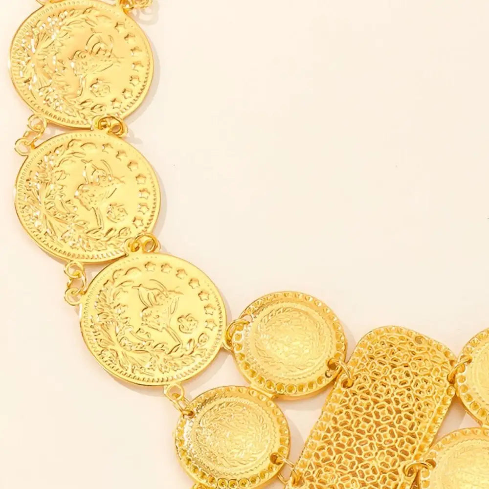 Gold coin belt with dangling pendants from Gold Coin and Bar Mesh Belt collection