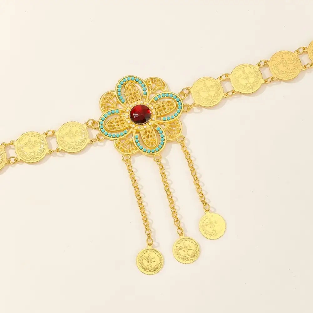 Gold coin belt featuring a decorative floral centerpiece for stylish accessorizing