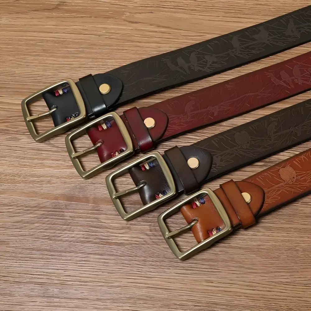 Set of four leather belts with brass buckles showcasing stylish men’s accessories